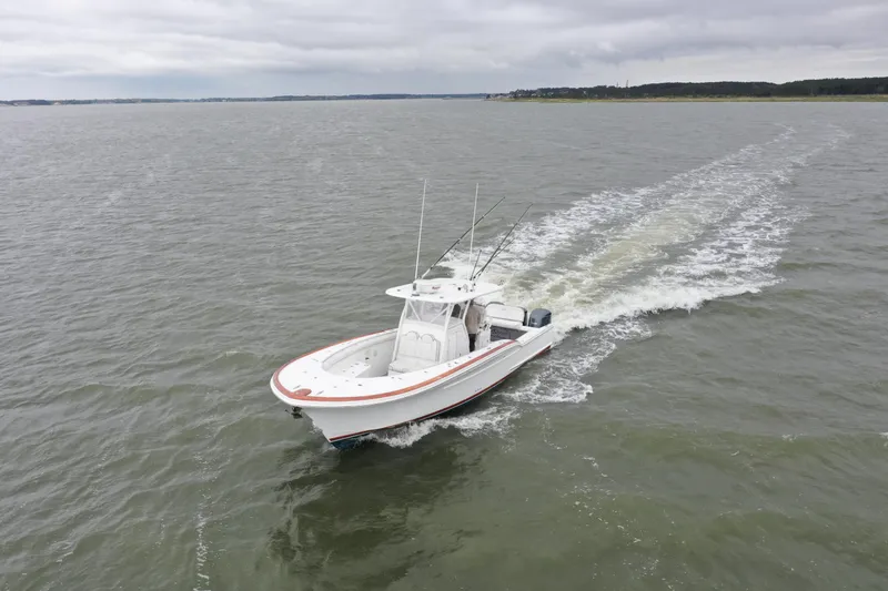 Slide: The Image of 2018 Buddy Davis 34 boat cruising on open water. - 4