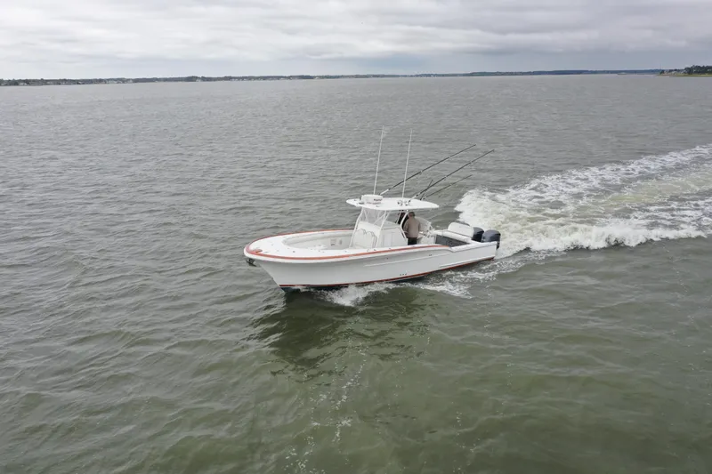 Slide: The Image of 2018 Buddy Davis 34 boat cruising on open water. - 5