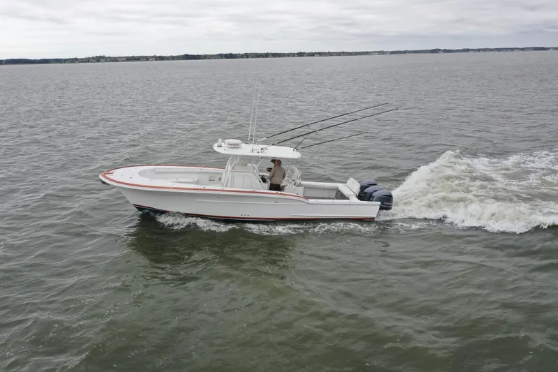 Slide: The Image of 2018 Buddy Davis 34 boat cruising on open water. - 6