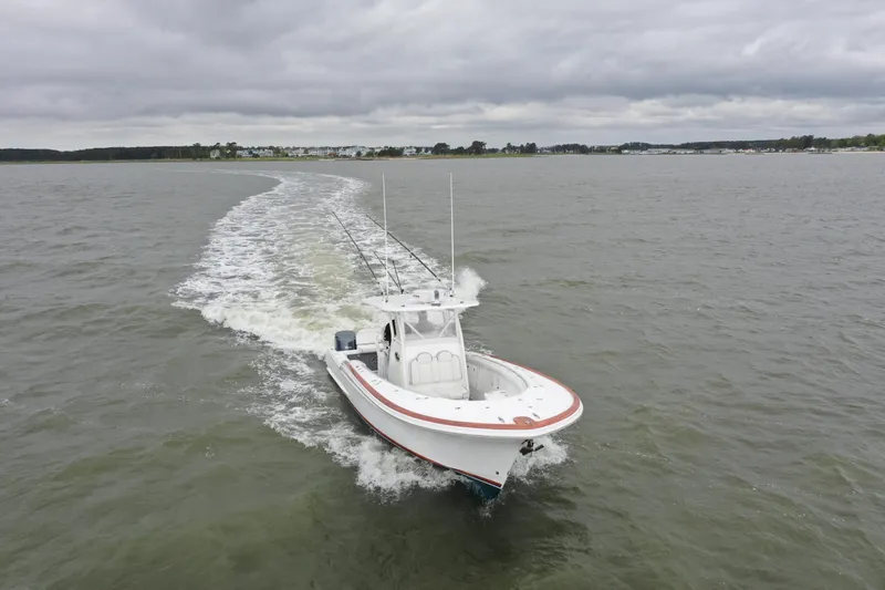 Slide: The Image of 2018 Buddy Davis 34 boat cruising on a cloudy day. - 9