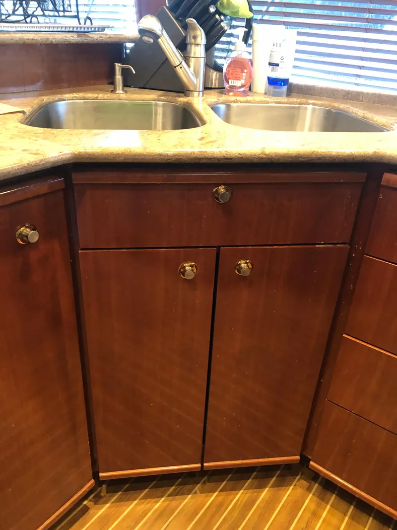 Slide: The Image of Meridian 580 Pilothouse yacht kitchen with double sink and wooden cabinets. - 37