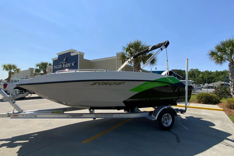 Slide: The Image of 2024 Starcraft SVX 171 boat on a trailer in a parking lot. - 4
