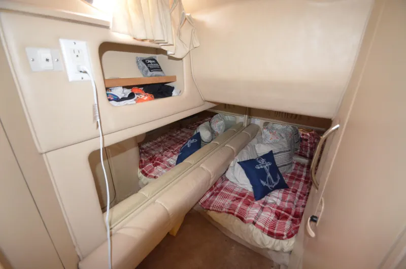 Slide: The Image of Cozy cabin interior of 1998 Sea Ray 310 boat with bunk beds and nautical decor. - 15
