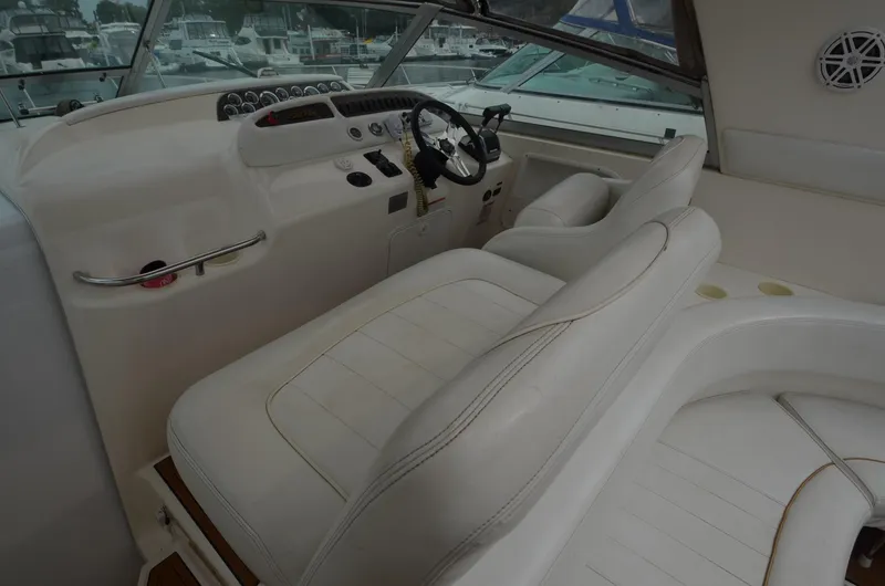 Slide: The Image of 1998 Sea Ray 310 boat cockpit with white leather seats and control panel. - 17