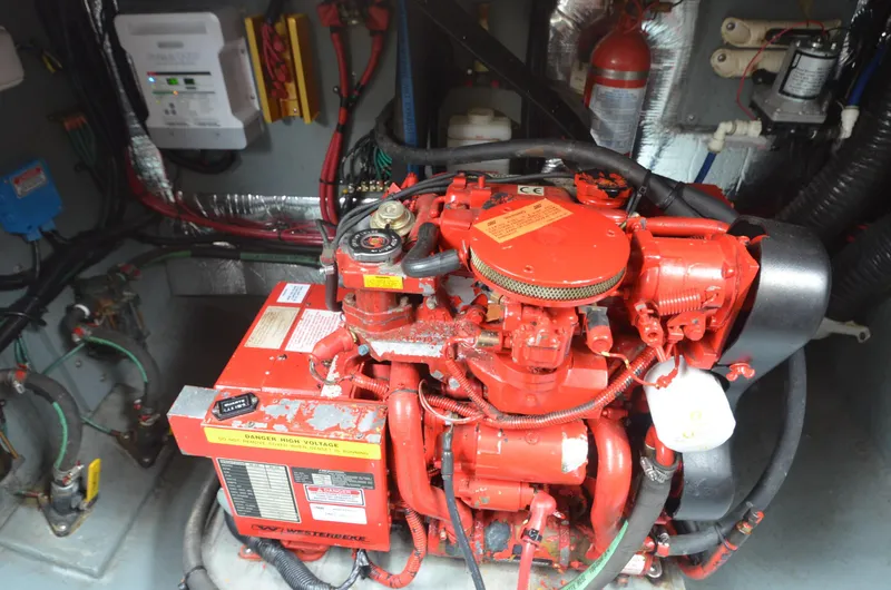 Slide: The Image of Engine compartment of a 1998 Sea Ray 310 boat with red engine components. - 20