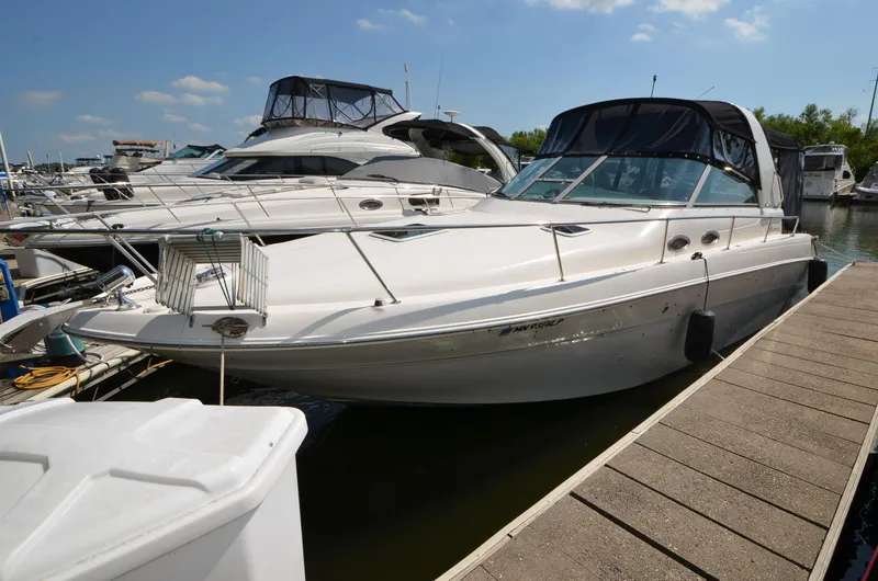 Slide: The Image of 1998 Sea Ray 310 boat docked at a marina on a sunny day. - 3
