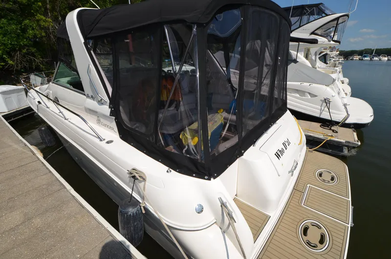 Slide: The Image of 1998 Sea Ray 310 boat docked at marina with black canopy. - 4