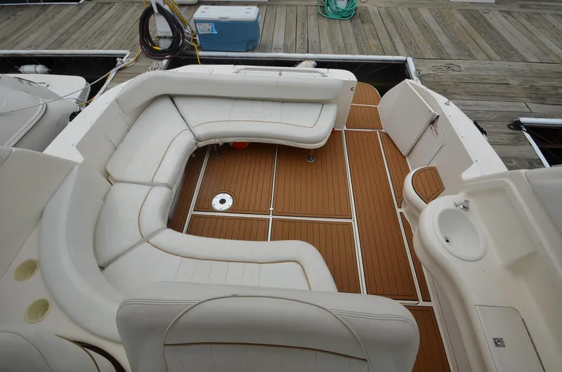 Slide: The Image of 1998 Sea Ray 310 boat with spacious seating and teak flooring. - 6