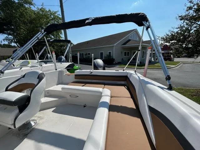 Slide: The Image of 2024 Starcraft SVX 191 boat with seating and canopy in a residential area. - 15