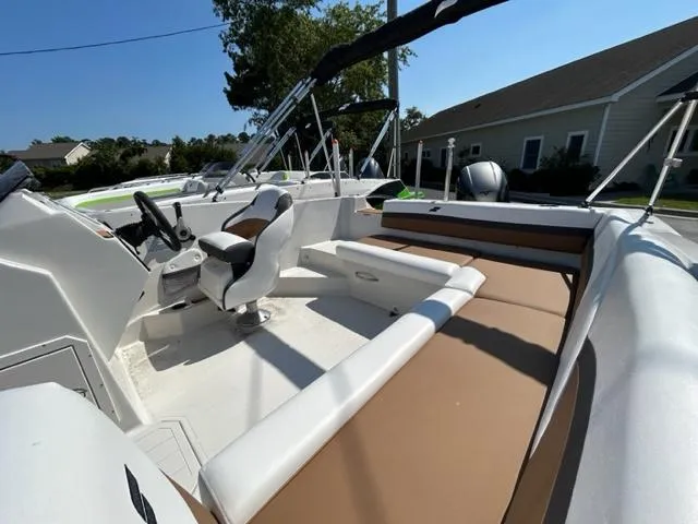 Slide: The Image of 2024 Starcraft SVX 191 boat interior with white and brown seating. - 16