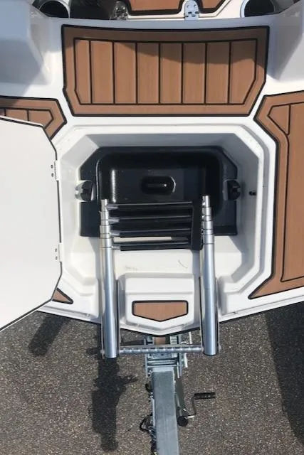 Slide: The Image of 2024 Starcraft SVX 211 boat with a foldable ladder and storage compartment. - 12