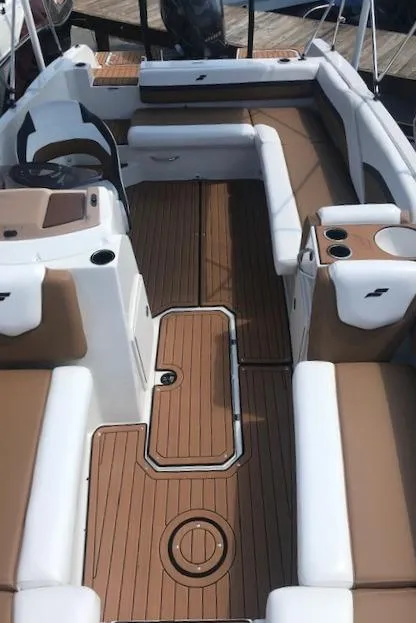 Slide: The Image of 2024 Starcraft SVX 211 boat interior with brown and white seating. - 13