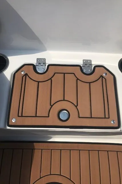 Slide: The Image of 2024 Starcraft SVX 211 boat deck with teak finish and storage compartment. - 14