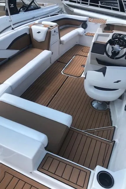 Slide: The Image of 2024 Starcraft SVX 211 boat interior with brown and white seating. - 18