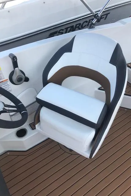 Slide: The Image of Captain's chair on 2024 Starcraft SVX 211 boat with teak flooring. - 8