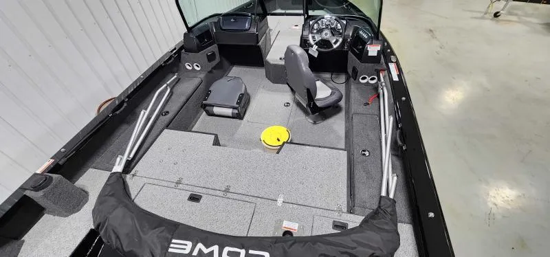 Slide: The Image of 2023 Lowe FM18PW fishing boat interior with steering console and seating. - 2
