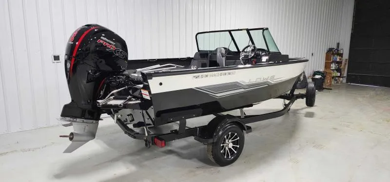 Slide: The Image of 2023 Lowe FM18PW fishing boat with trailer in a garage. - 3