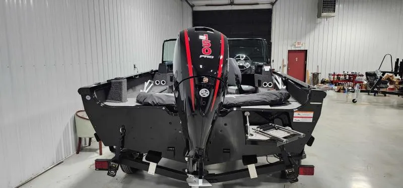Slide: The Image of 2023 Lowe FM18PW boat with outboard motor in a storage facility. - 4