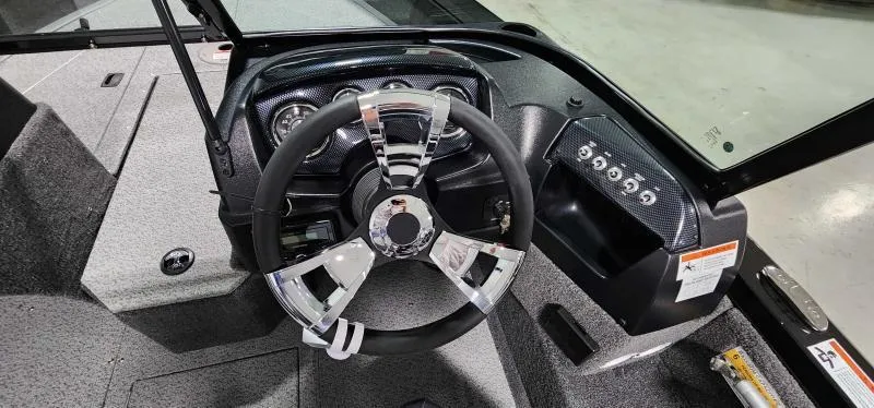 Slide: The Image of 2023 Lowe FM18PW boat dashboard with steering wheel and control panel. - 5