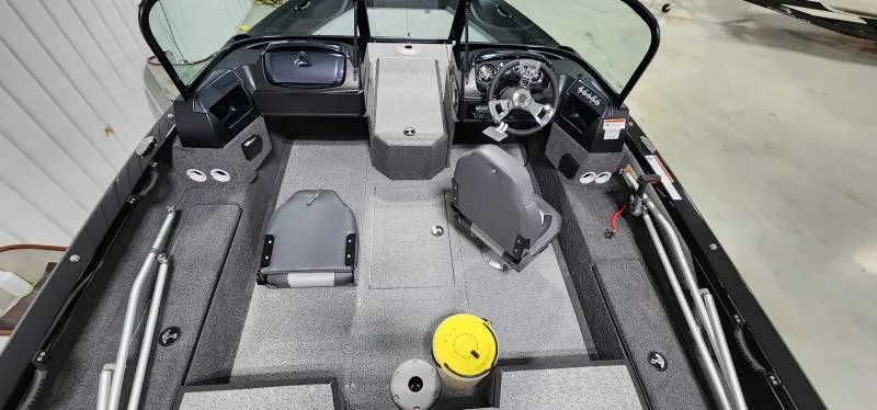 Slide: The Image of 2023 Lowe FM18PW fishing boat interior with steering console and seating. - 6