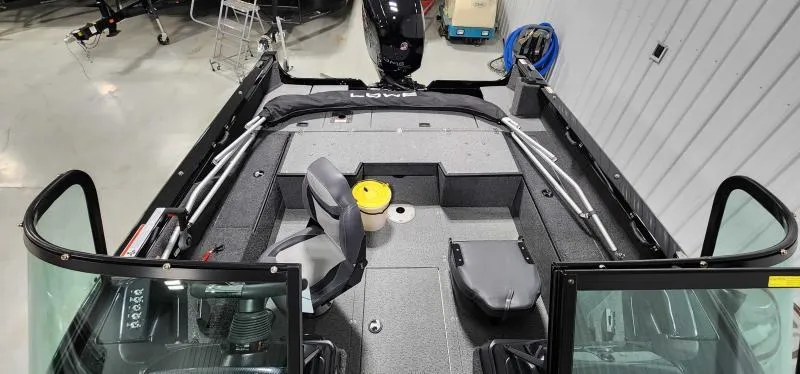 Slide: The Image of 2023 Lowe FM18PW fishing boat interior with seating and storage compartments. - 7