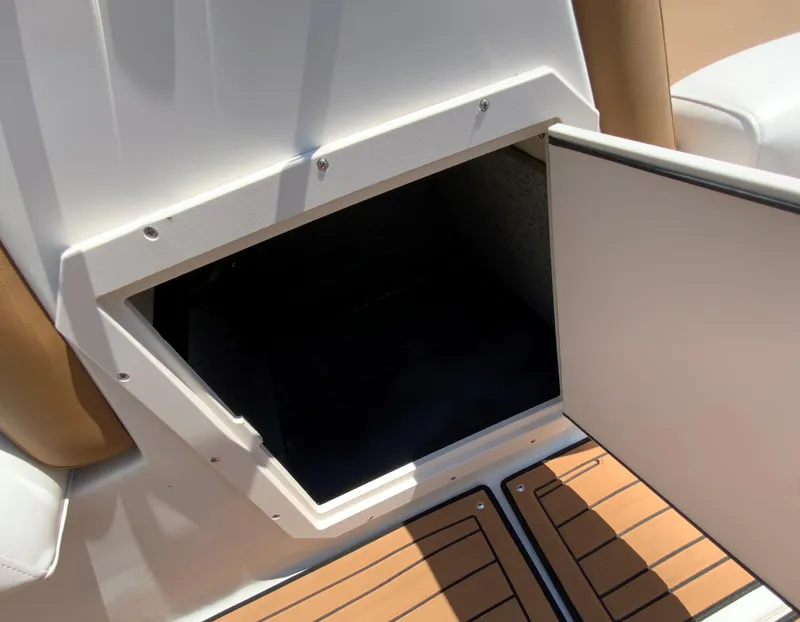 Slide: The Image of Open storage compartment on 2024 Starcraft SVX 211 boat with teak flooring. - 19