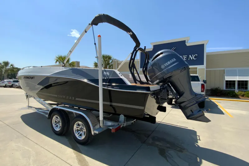 Slide: The Image of 2024 Starcraft SVX 211 boat on trailer with Yamaha outboard motor. - 2