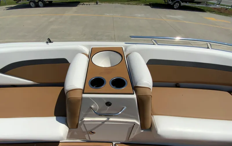Slide: The Image of 2024 Starcraft SVX 211 boat interior with tan and white seating and cup holders. - 20