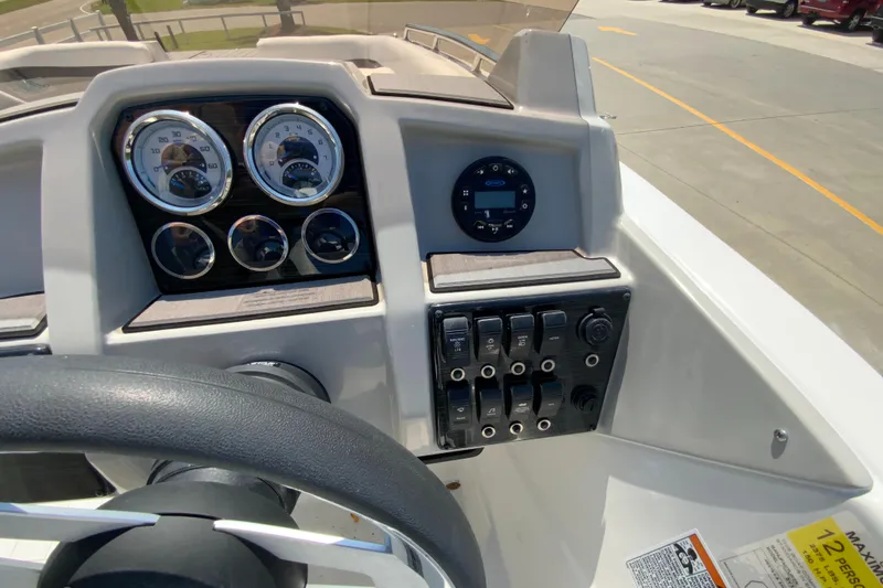 Slide: The Image of 2024 Starcraft SVX 191 boat dashboard with gauges and controls. - 14