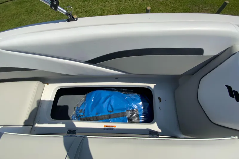 Slide: The Image of 2024 Starcraft SVX 191 boat storage compartment with blue cover. - 17