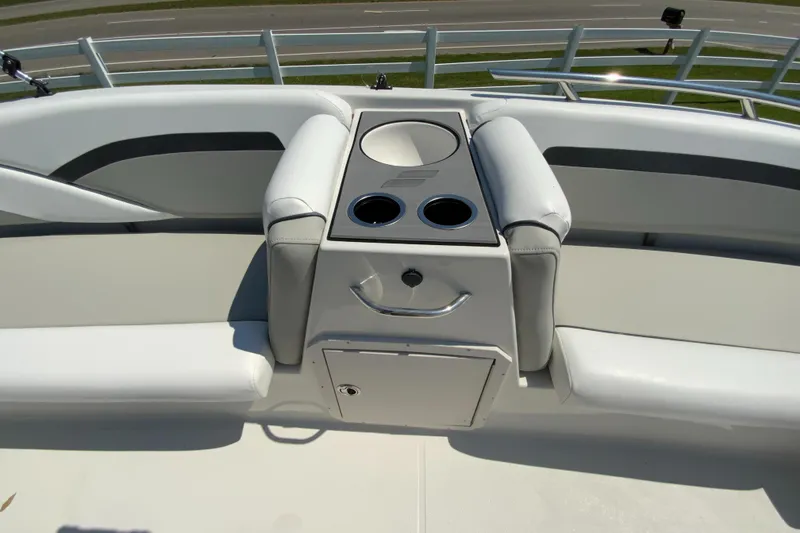 Slide: The Image of 2024 Starcraft SVX 191 boat seating area with cup holders and storage compartment. - 19