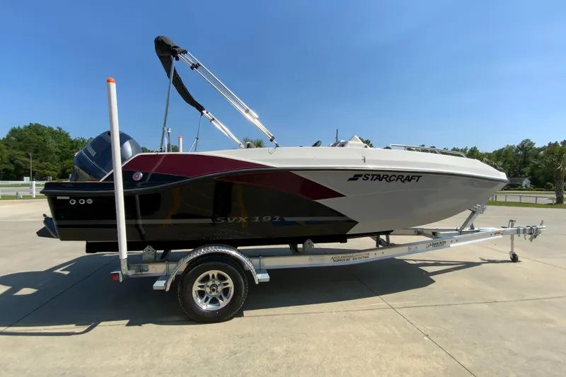 Slide: The Image of 2024 Starcraft SVX 191 boat on a trailer in a parking lot. - 2