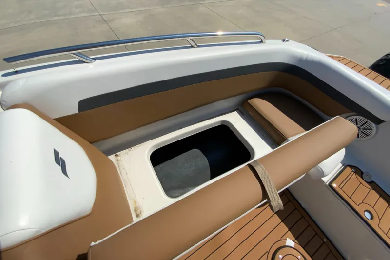 Slide: The Image of 2024 Starcraft SVX 191 boat interior with storage compartment and brown seating. - 22