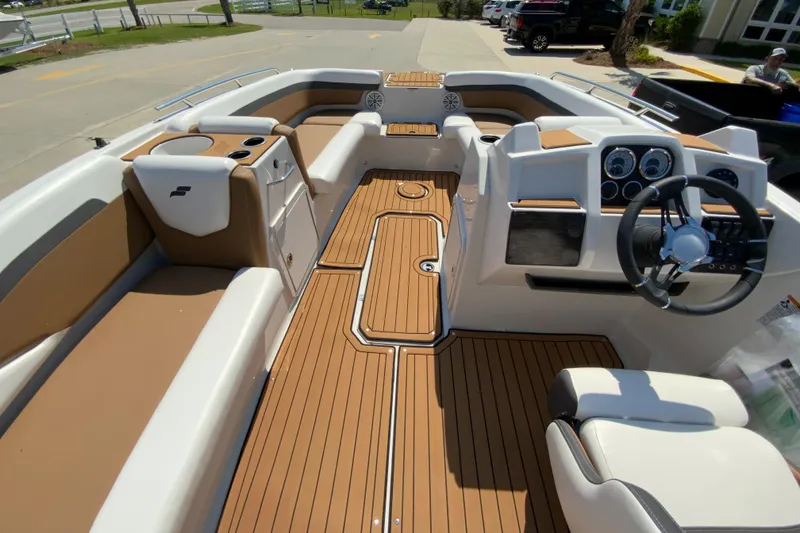 Slide: The Image of 2024 Starcraft SVX 191 boat interior with tan and white seating and modern dashboard. - 9