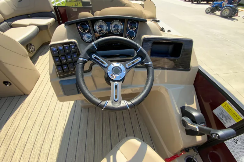 Slide: The Image of 2024 Starcraft SLS 3 boat dashboard with steering wheel and control panel. - 13