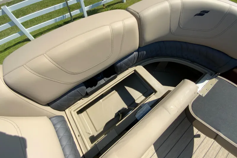 Slide: The Image of 2024 Starcraft SLS 3 boat with open storage compartment and beige seating. - 18