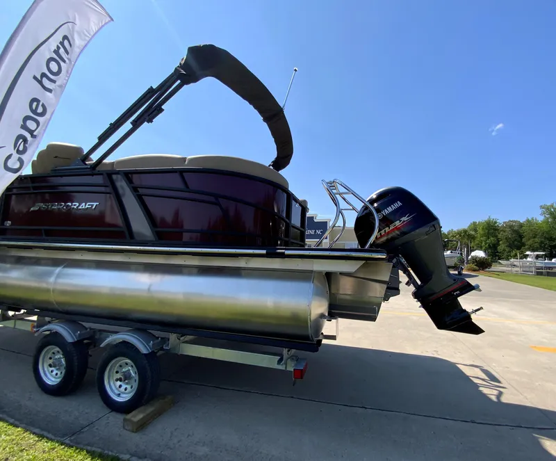 Slide: The Image of 2024 Starcraft SLS 3 pontoon boat on trailer with Yamaha outboard motor. - 4