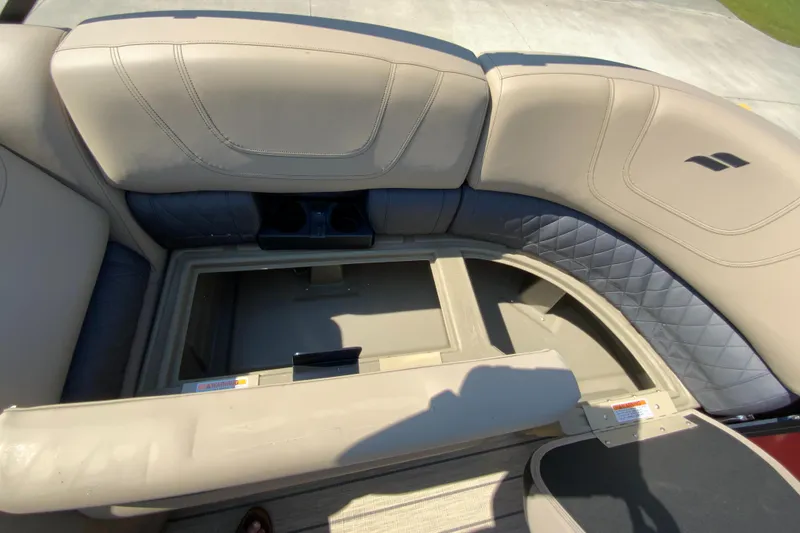 Slide: The Image of 2024 Starcraft SLS 3 boat with open storage compartment and beige seating. - 8