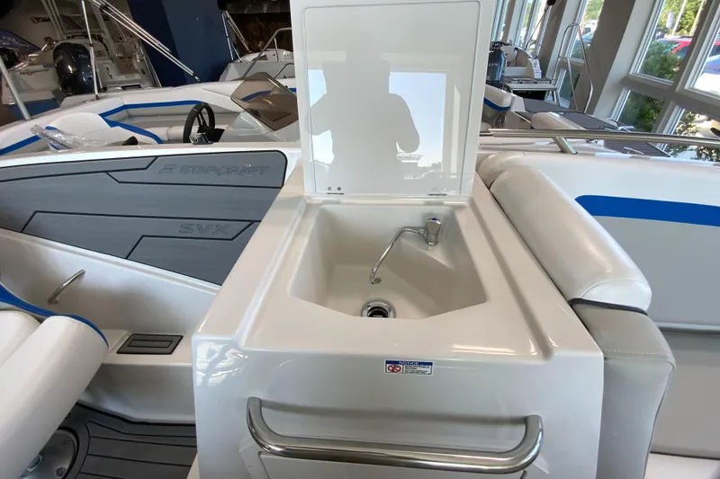 Slide: The Image of 2024 Starcraft SVX 231 boat interior with sink and seating area. - 11