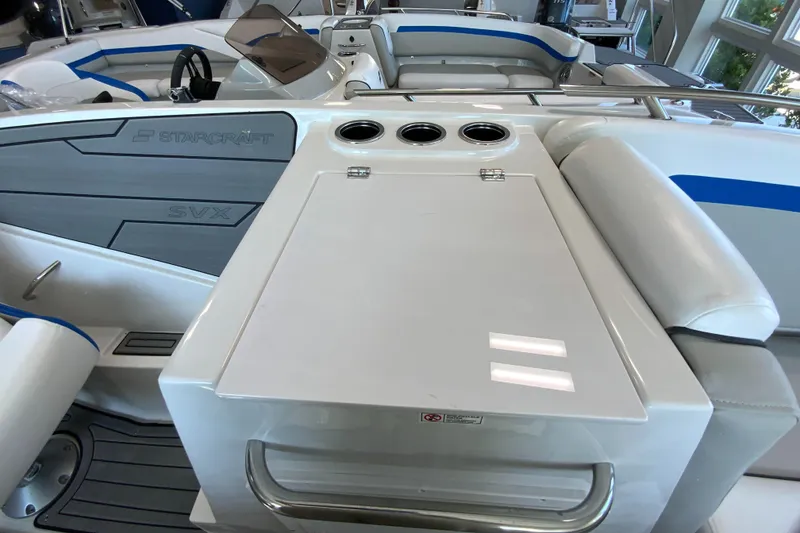 Slide: The Image of 2024 Starcraft SVX 231 boat interior with seating and storage compartments. - 13