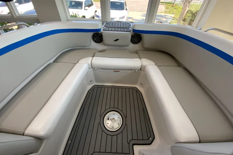 Slide: The Image of 2024 Starcraft SVX 231 boat interior with gray seating and blue accents. - 15