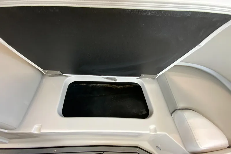 Slide: The Image of 2024 Starcraft SVX 231 boat storage compartment with open lid. - 18