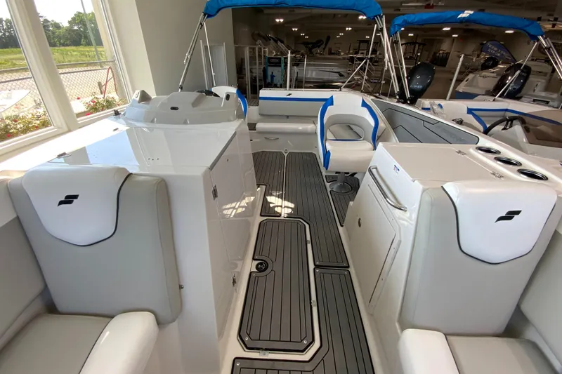 Slide: The Image of 2024 Starcraft SVX 231 boat interior with white and blue seating, modern design. - 21