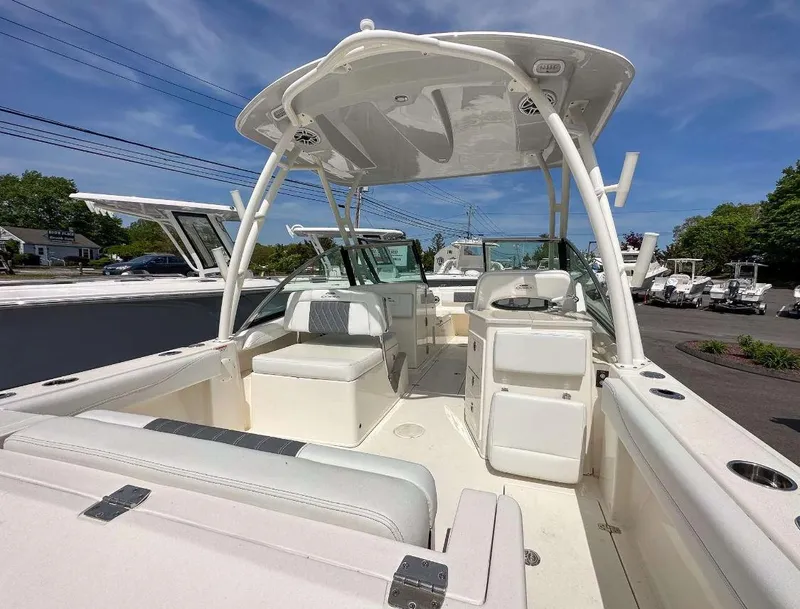 Slide: The Image of 2023 Cobia 240 Dual Console boat interior with seating and helm station. - 2