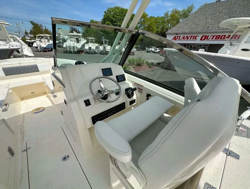 Slide: The Image of 2023 Cobia 240 Dual Console boat interior with helm and seating. - 4