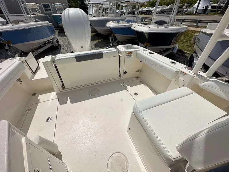 Slide: The Image of 2023 Cobia 240 Dual Console boat interior with seating and storage compartments. - 7