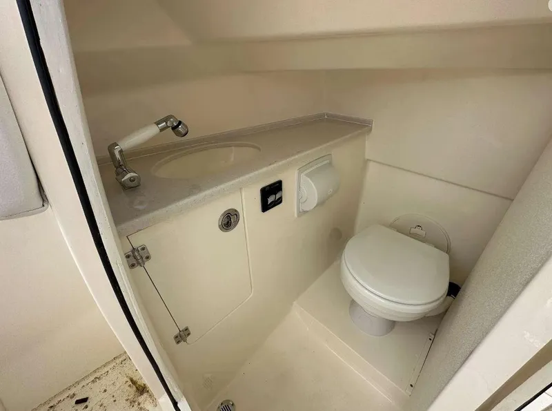 Slide: The Image of 2023 Cobia 240 Dual Console boat interior bathroom with sink and toilet. - 9