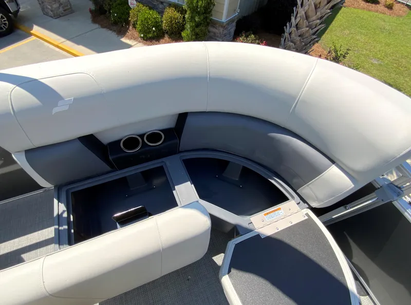 Slide: The Image of 2024 Starcraft LX20 R pontoon boat with spacious seating and storage compartments. - 12