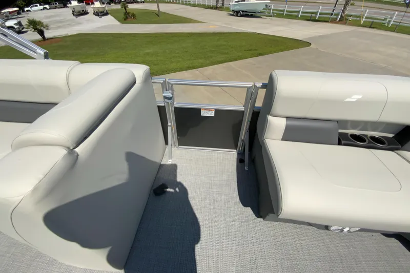 Slide: The Image of 2024 Starcraft LX20 R pontoon boat interior with beige seating. - 20