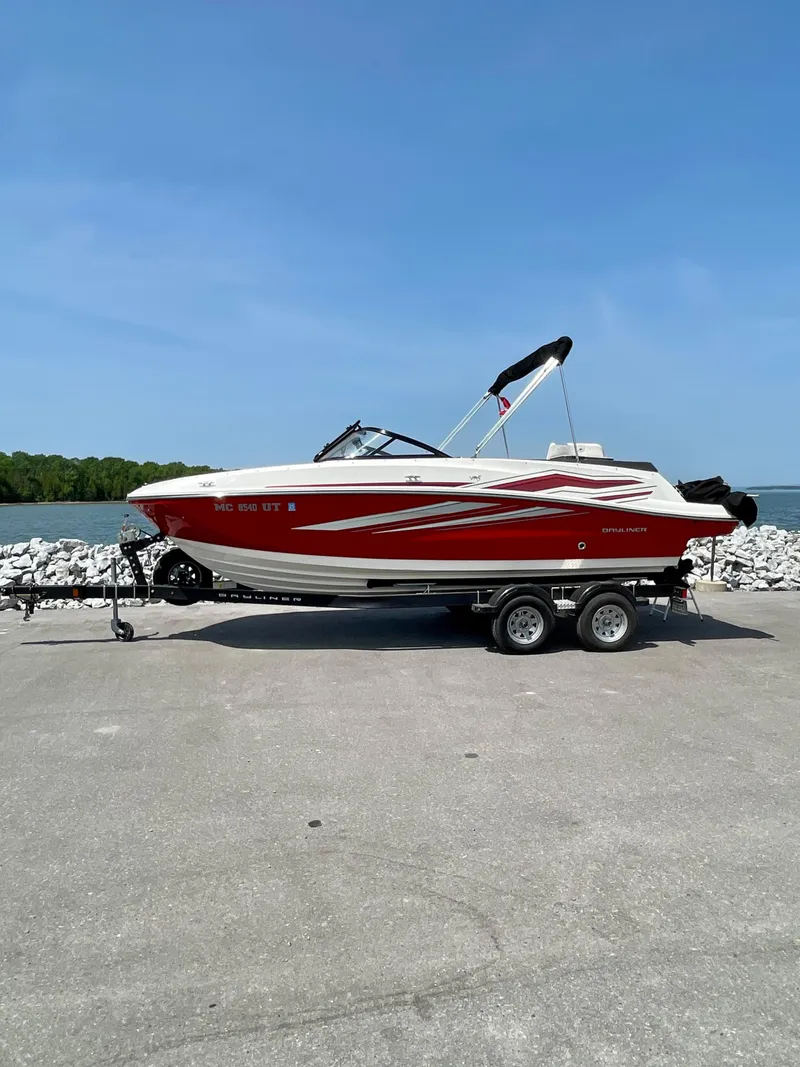 The Image of 2021 Bayliner VR5 boat on trailer by waterfront, clear sky background. - 0